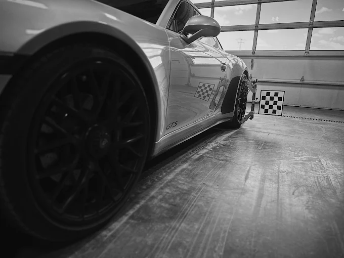 Sports car in side profile next to a calibration target board, ADASquare bay