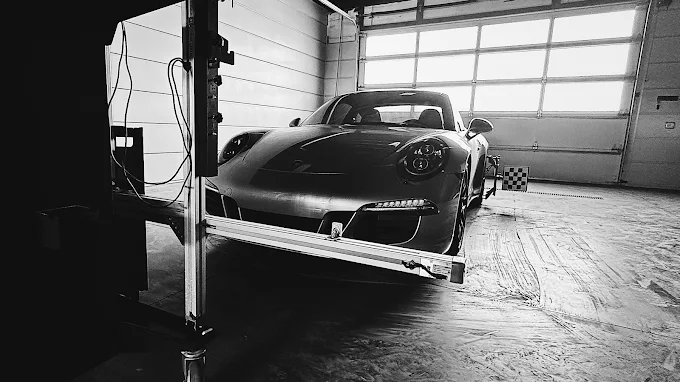 Sports car positioned for diagnostics in front of the ADASquare calibration rig